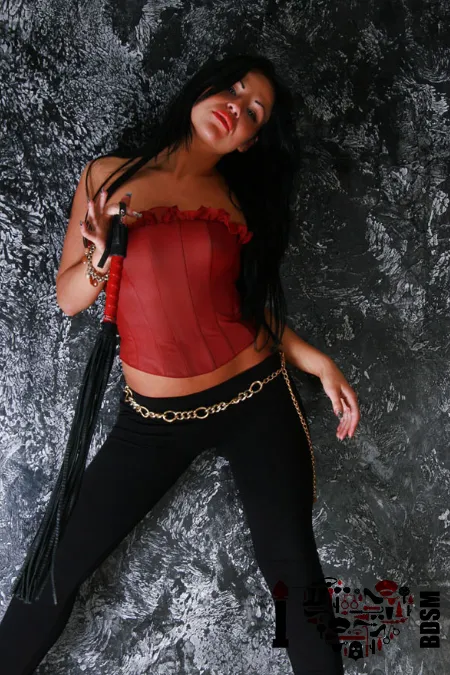 Maitresse glamour en rouge et noir coup de fouet facile domina extravagante en rouge et noir coup de fouet